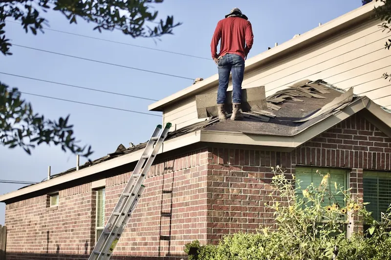 Professional roofer working on a residential roof in Natural Woods